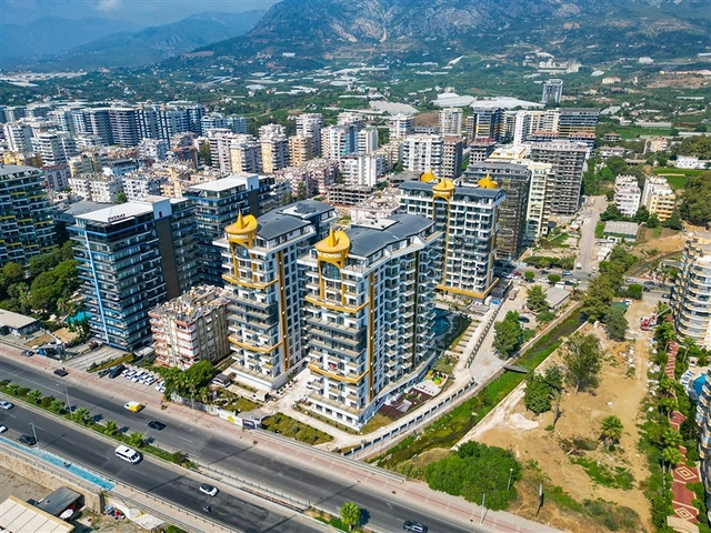 This functional one-bedroom apartment, with a total area of ​​57 sq m, is located on the second floor. The layout includes a bright living room with a kitchen area, a separate bedroom, a bathroom, and a balcony. The interior is fully furnished and equipped with appliances, air conditioning, ceramic tile flooring, a granite countertop in the kitchen, and a shower in the bathroom. This apartment is ideal for comfortable living in a vibrant coastal area. The project's infrastructure is designed for relaxation and an active lifestyle: an outdoor pool, an indoor pool, a children's pool, a water park, a sauna, a hammam, a steam room, a massage area, a fitness center, a tennis court, a volleyball court, a basketball court, table tennis, billiards, a children's play area, a green garden, a barbecue area, walking paths, a games room, internet access, television, a café, a pool bar, a conference room, a generator, outdoor parking, indoor parking, security, and a video surveillance system. Sea View Apartment with Furniture on Cebeci Towers Alanya Turkey