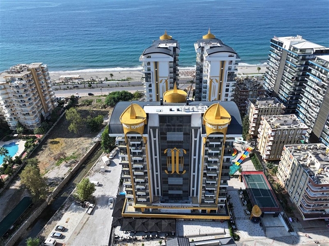This functional one-bedroom apartment, with a total area of ​​57 sq m, is located on the second floor. The layout includes a bright living room with a kitchen area, a separate bedroom, a bathroom, and a balcony. The interior is fully furnished and equipped with appliances, air conditioning, ceramic tile flooring, a granite countertop in the kitchen, and a shower in the bathroom. This apartment is ideal for comfortable living in a vibrant coastal area. The project's infrastructure is designed for relaxation and an active lifestyle: an outdoor pool, an indoor pool, a children's pool, a water park, a sauna, a hammam, a steam room, a massage area, a fitness center, a tennis court, a volleyball court, a basketball court, table tennis, billiards, a children's play area, a green garden, a barbecue area, walking paths, a games room, internet access, television, a café, a pool bar, a conference room, a generator, outdoor parking, indoor parking, security, and a video surveillance system. Sea View Apartment with Furniture on Cebeci Towers Alanya Turkey