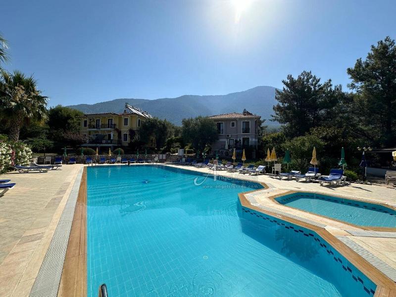 Bargain 2 Bedroom Furnished Property in Hisaronu Oludeniz Fethiye. Located in a gated complex with will landscaped green gardens and Large Shared Pool