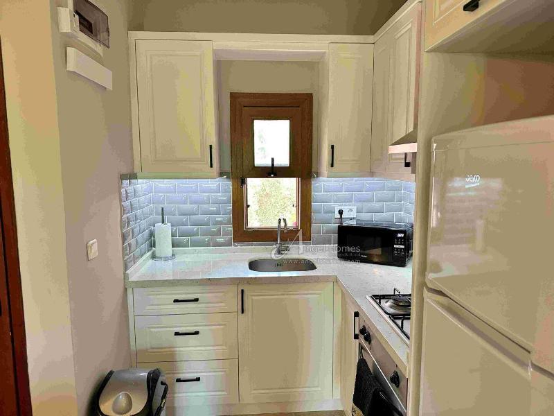 Bargain 2 Bedroom Furnished Property in Hisaronu Oludeniz Fethiye. Located in a gated complex with will landscaped green gardens and Large Shared Pool