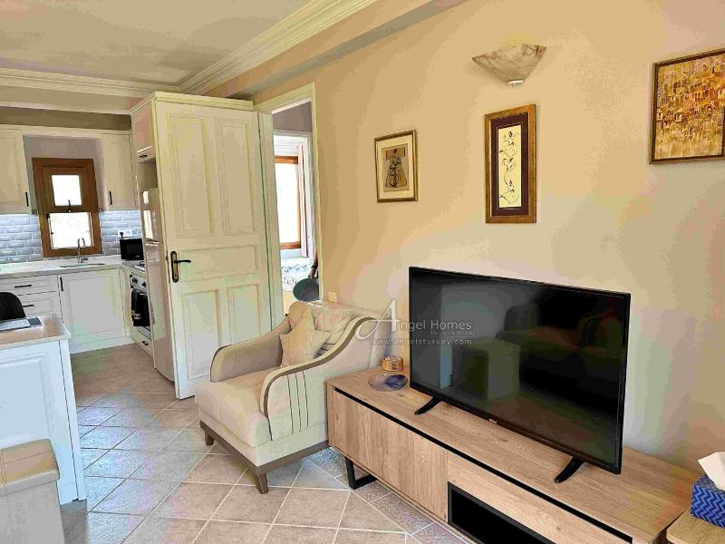 Bargain 2 Bedroom Furnished Property in Hisaronu Oludeniz Fethiye. Located in a gated complex with will landscaped green gardens and Large Shared Pool